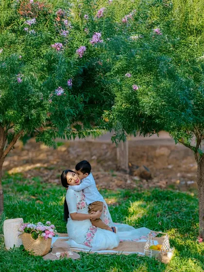 The bond between a mother and her child is pure magic. During a sunny picnic session, we captured this tender hug, a quiet moment of connection amidst the playful energy of the day. These are the memories we aim to make last forever.