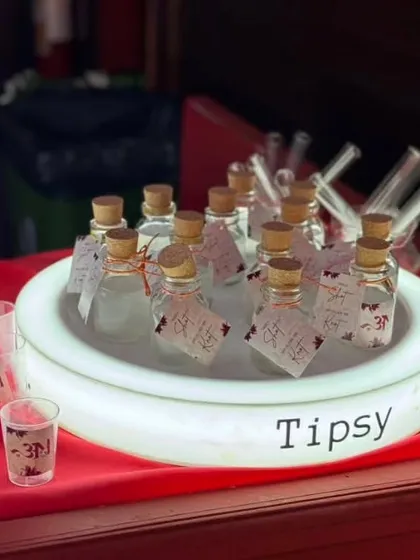 Our custom alcoholic shots, served in mini glass bottles with personalized tags. This glowing display makes for an inviting and unique shot station at any event.