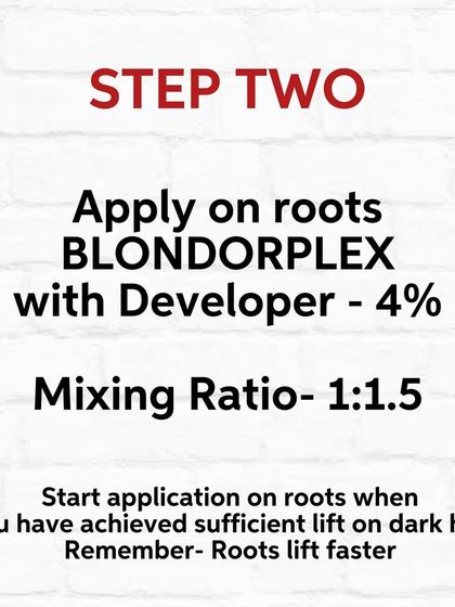 Step Two of lightening. Once the mid-lengths have lifted, I apply a new mix to the root area, which lifts faster.