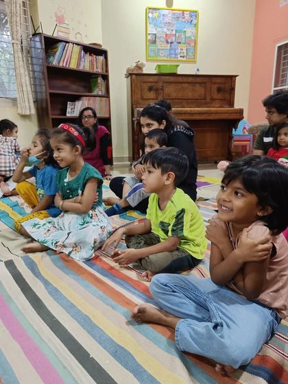 The children's faces light up with excitement and happiness during a story session.