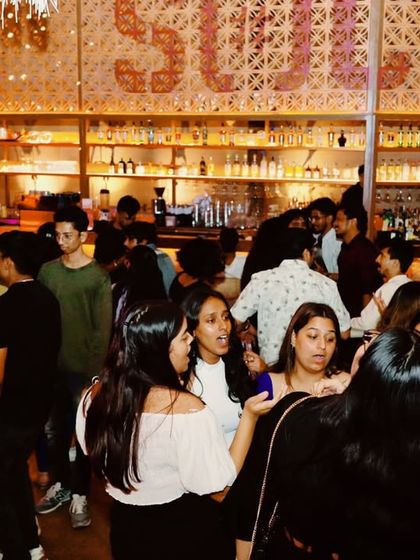 The crowd mingling and dancing near the bar at JP Nagar Social.