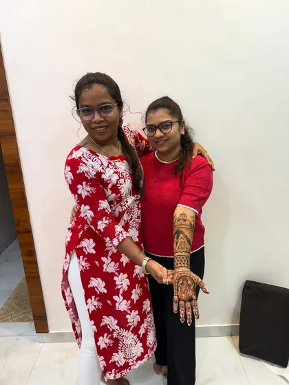 A student proudly displaying her intricate bridal arm design. In my classes, you learn to create complete, balanced, and beautiful bridal looks from hand to elbow.