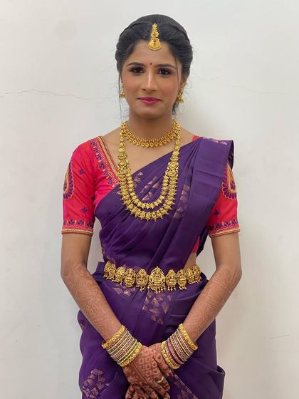 This bride is ready for her big day in a beautiful purple Kanchipuram saree. I created a look with defined eyes and a soft pink lip to complement her vibrant outfit.