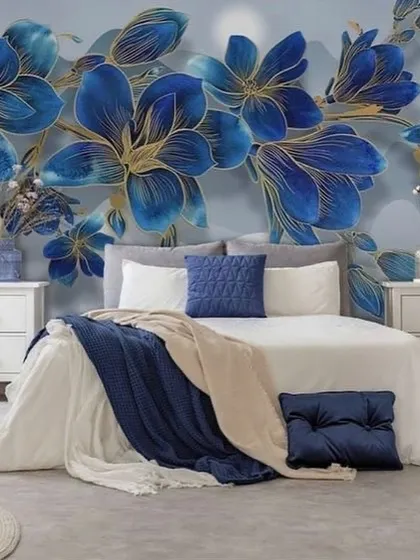 A beautiful bedroom accent wall with a 3D mural of large, royal blue flowers with golden edges. The design adds a pop of color and elegance.