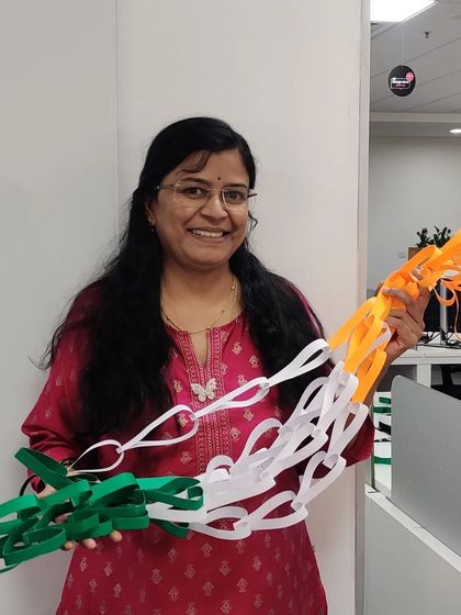 A happy moment holding the materials for our Independence Day craft project.