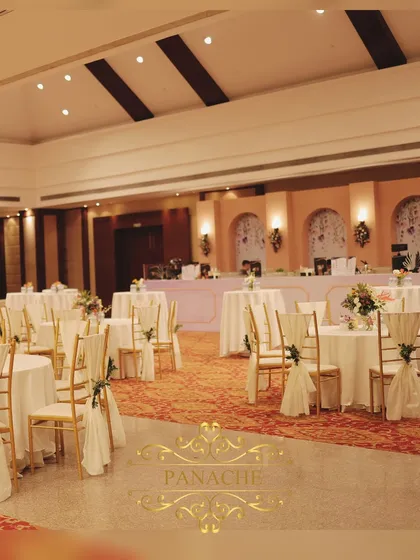 A wide view of the banquet hall, showing the elegant guest seating arrangement for the Roka ceremony.