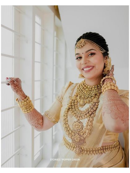 A beautiful portrait of the bride by the window, her happiness evident in her radiant smile.