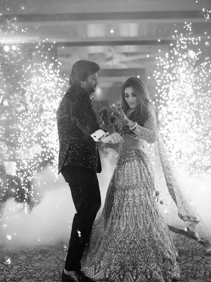 A timeless black and white shot capturing the couple's dance, surrounded by the magical glow of cold pyros. This shows how I use special effects to create dramatic and artistic memories.