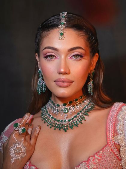 Fresh and dewy with a pop of color. This look for a Mehendi ceremony features a bright pink inner corner liner, adding a fun and modern twist.