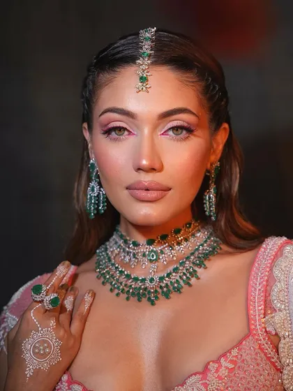 Fresh and dewy with a pop of color. This look for a Mehendi ceremony features a bright pink inner corner liner, adding a fun and modern twist.