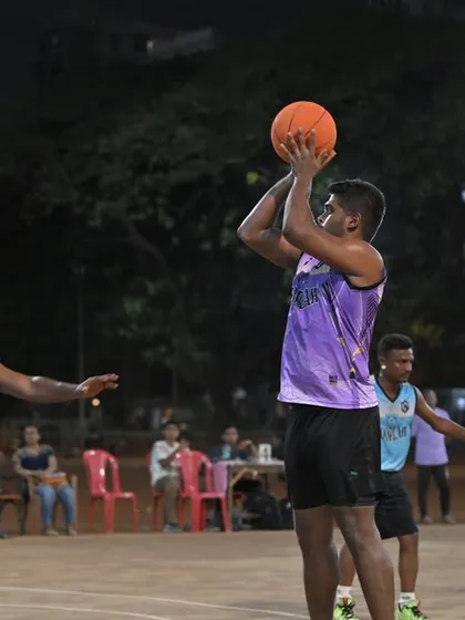A player rises for a jump shot over the defense. Capturing the skill and athleticism on display at our men's league games.