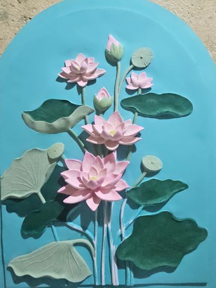 Here, the casted lotus mural has been painted with its base colors. The vibrant pinks and greens begin to define the form, but the final detailing and shading are yet to come.
