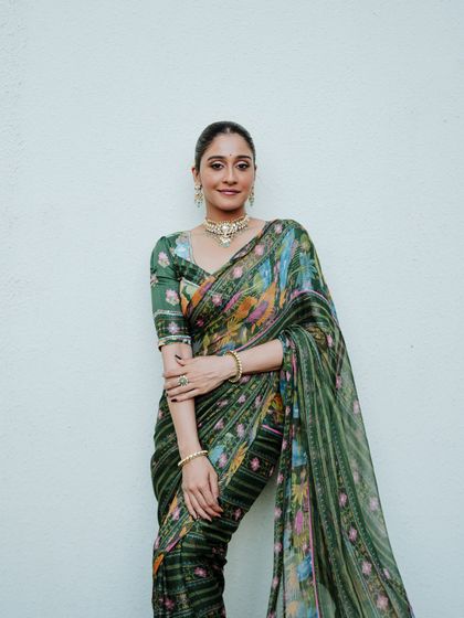 A poised and polished portrait against a clean white background, making the vibrant saree the hero of the image. This is ideal for fashion lookbooks and brand promotions.