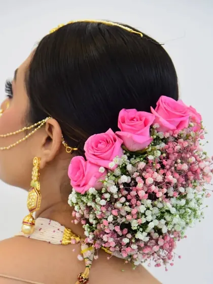 A classic floral bun is always a beautiful choice for traditional events. I created this intricate low bun and adorned it with a combination of fresh pink roses and baby's breath, ensuring it looks stunning from every angle.