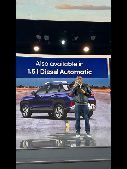 A speaker on stage at the Hyundai Venue launch, with the vehicle visible in the background. We managed the teleprompter and all on-stage technicals for a seamless presentation.