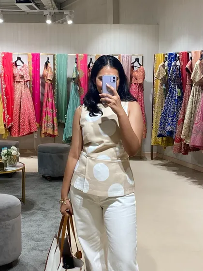 A quick selfie during a sourcing trip to Pernia's Pop-Up Shop. The rainbow of lehengas behind me is just a small peek at the incredible variety they offer.