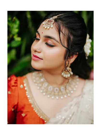 A serene and beautiful close-up of the bride on her engagement day, her eyes closed in a moment of quiet joy.