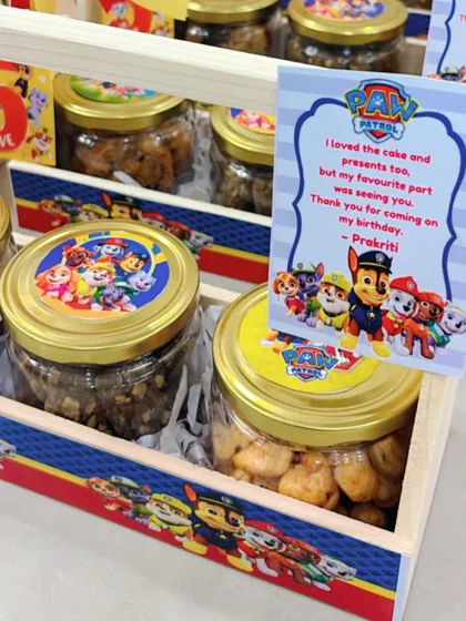 A close-up of the 'Paw Patrol' basket, featuring a personalized thank you card from the birthday girl, Prakriti.