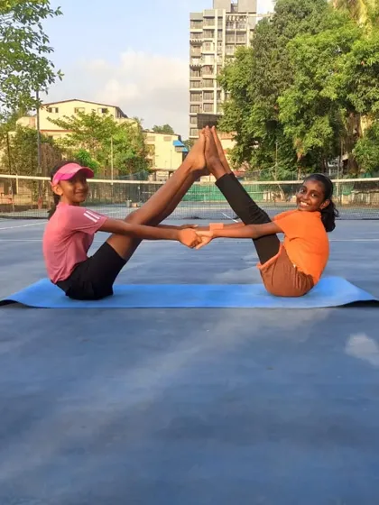 Flexibility and teamwork are just as important as strength. Our players practice partner yoga to improve balance and prevent injuries, fostering a supportive team environment.