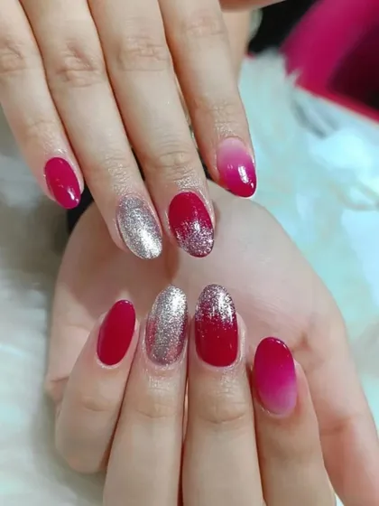 A fun and vibrant set combining glossy red, a red-to-pink ombre, and full-coverage silver glitter nails.
