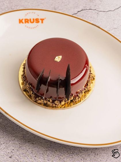 Got a sweet tooth? This cherry and chocolate pastry is a work of art, with a beautiful mirror glaze and layers of rich flavor.