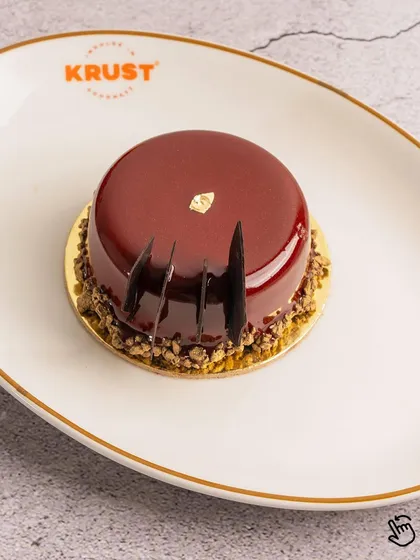 Another view of the Cherry and Chocolate pastry, showcasing its elegant shape and flawless finish. A perfect little indulgence.
