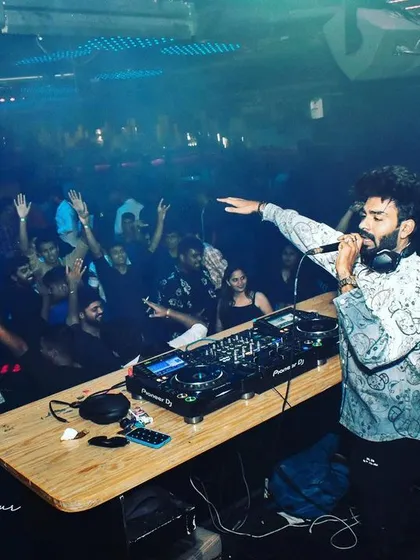 Getting the crowd to put their hands up at Helium Pune. My goal is to make every set an interactive experience.