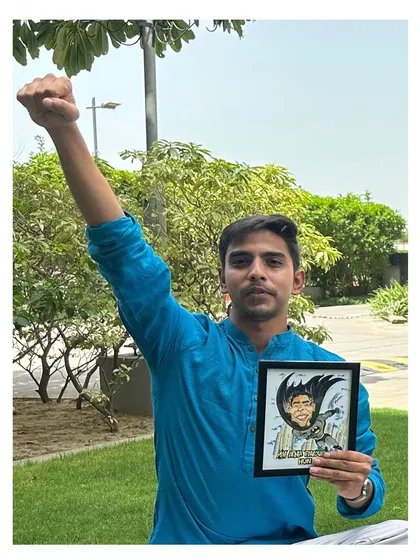 The hero himself! A proud client posing with his custom Batman caricature, striking a power pose that matches the artwork perfectly.