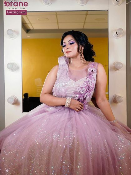 A full length shot of a student's modern bridal look in a beautiful lavender gown. This could also serve as a stunning reception or engagement party look.