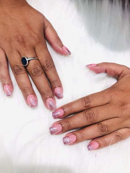 A simple and sweet design with a pink base and a silver glitter tip.