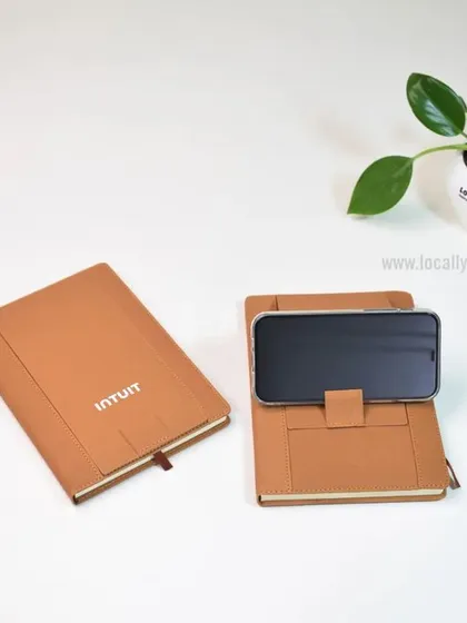 A closer look at the 2-in-1 diary and mobile holder we created for Intuit. The tan-colored cover and clean branding make for a sophisticated and highly useful corporate gift.
