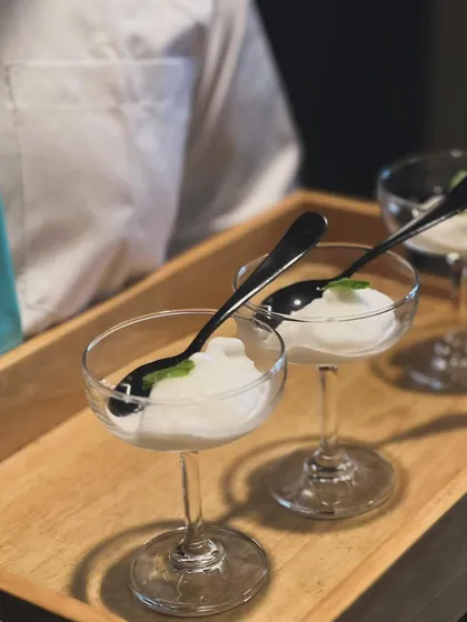 A refreshing Lemon Sorbet served in a coupe glass. It acts as a perfect palate cleanser or a light and zesty end to a rich meal.