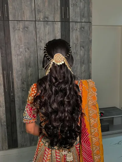 The back view of this gorgeous engagement hairstyle, showing the detailed placement of the accessory and the texture of the soft curls.