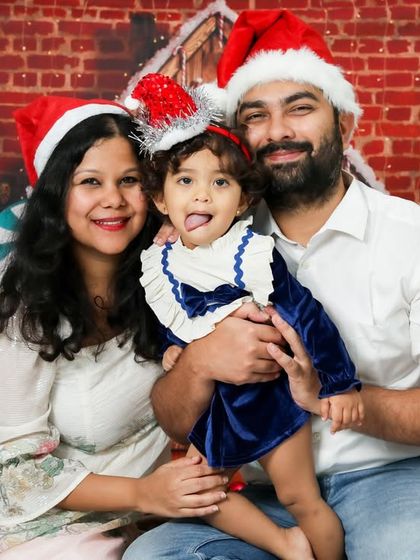A fun and festive family Christmas portrait. The Santa hats and silly faces show that the holidays are all about being together and having a good time.