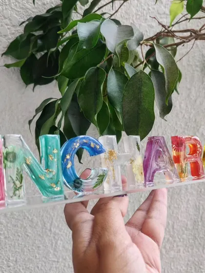 This custom resin name stand is so bright and cheerful. Each letter has a different color and contains real preserved flowers, making it a unique piece of decor for a desk or shelf.