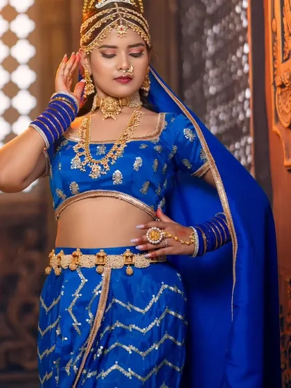 We love collaborating on creative and themed photoshoots. This royal blue ensemble is complemented by our unique gold jewellery, including a multi-layered headpiece, creating a look fit for a queen.