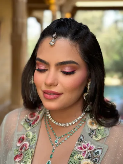 A close-up of a vibrant Mehendi look. The bright pink eyeshadow adds a fun pop of color, perfect for a festive daytime celebration.