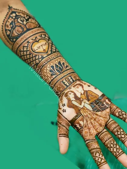 A single-hand view of an engagement mehndi, focusing on the romantic couple portrait and the "We Said Yes" heart motif.