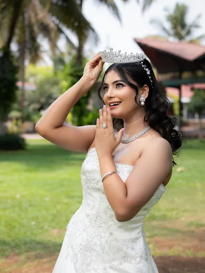 Capturing the pure joy of a bride-to-be. This classic white Christian bridal gown features beautiful subtle embroidery and a timeless silhouette. Paired with one of my sparkling tiaras, it creates an ethereal and unforgettable wedding day look.