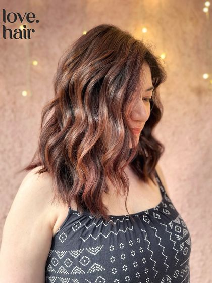 A side view of the mellow mahogany balayage, showing how the warm tones frame the face and add a beautiful glow.