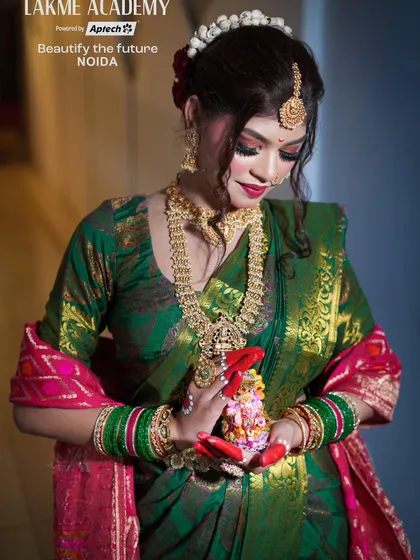 A beautiful shot of our model holding a small Ganesha idol, perfect for a festive-themed shoot. The makeup is traditional, with an emphasis on the eyes and gold jewelry.