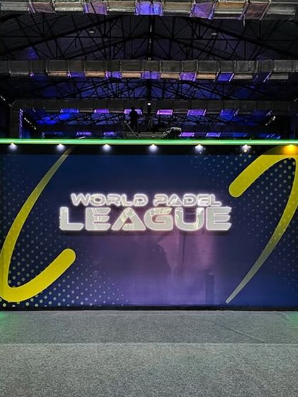 A branded photo-op wall with integrated LED screens and neon lighting for the World Padel League. We create these engaging installations for fans and media.