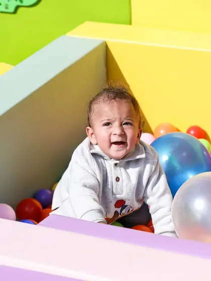 Just look at that happy face! Our ball pits are a huge hit with the tiniest party guests.