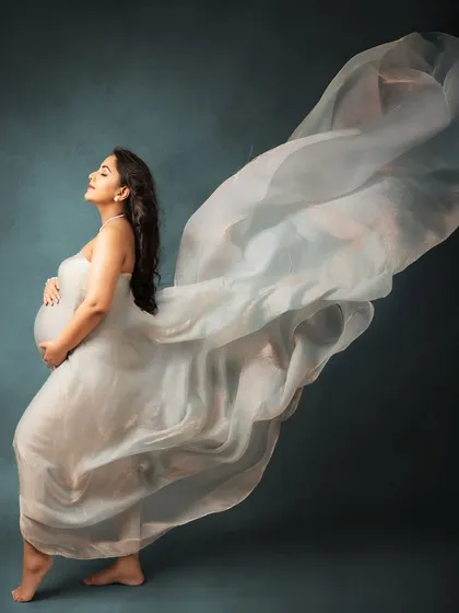 This is the magic of motherhood, captured in a single, flowing moment. In my studio, I use beautiful fabrics and soft lighting to create timeless portraits that feel like a work of art, celebrating your strength and grace.