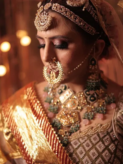 A detailed close-up of the oversized nath, a key element of this traditional bridal look, paired perfectly with the heavy necklace.
