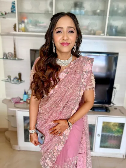The full look, showcasing the beautiful pink saree and the soft, romantic makeup and hairstyle.