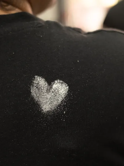A heart made of flour on the back of a team member's shirt. These are the little textures and moments from the Maska kitchen that we love.