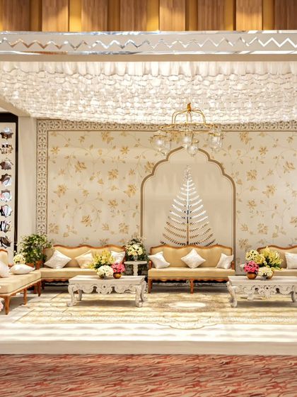 An elegant lounge seating area designed with a neutral color palette, intricate backdrops, and classic furniture. This space provided a comfortable and sophisticated retreat for guests during the festivities.