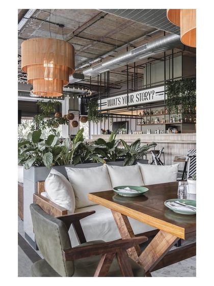 A cozy nook with comfortable lounge seating, perfect for guests who want a more relaxed and intimate dining experience. The wooden table and chairs add a touch of rustic charm.