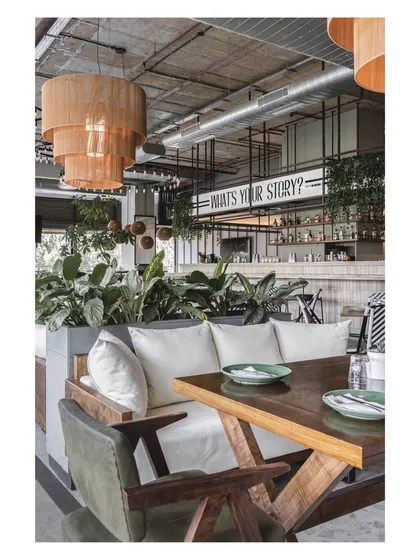 A cozy nook with comfortable lounge seating, perfect for guests who want a more relaxed and intimate dining experience. The wooden table and chairs add a touch of rustic charm.
